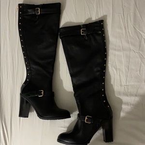 Gold grommet knee high, back zip boots.